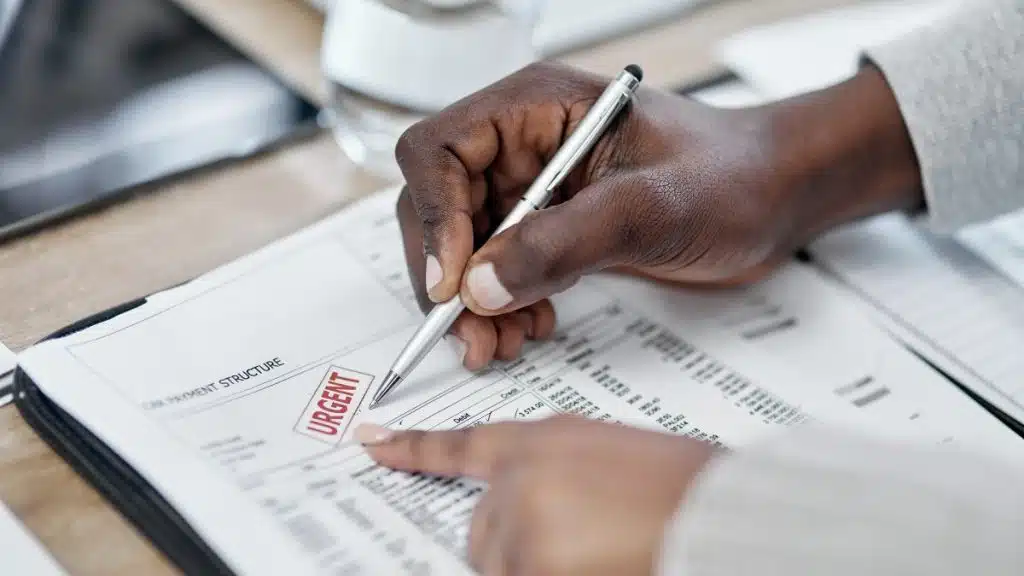 Borrower reviewing overdue mortgage paperwork as arrears become harder to manage in New Zealand