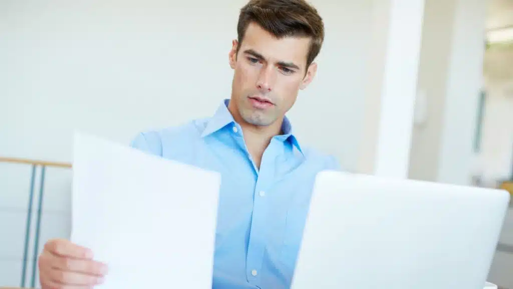 Borrower reviewing mortgage paperwork to understand what arrears means in New Zealand
